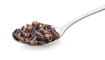 cloves spices in spoon on white background