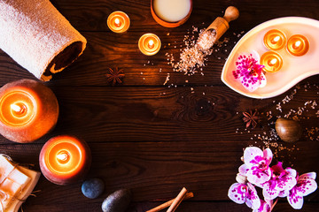 Spa concept with chocolate and candles on a wooden background.