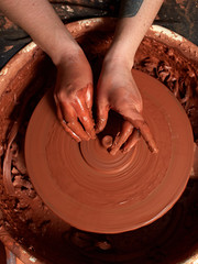 production process of pottery. Forming the clay cover of the kettle on the potter's wheel.