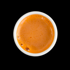 Carrot juice, fresh healthy drink. Top view, closeup. Isolated on black.