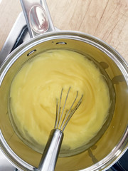 Fototapeta na wymiar cooking cream in sauté pan with whisk
