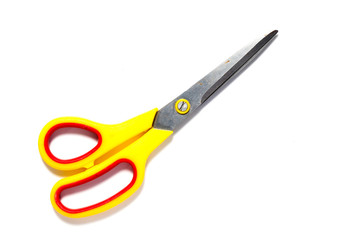 Metal scissors with yellow and red plastic holder on white background