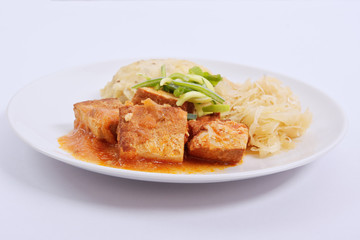 Tofu with cabbage and rice dumplings  on a white