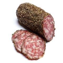 Dried organic salami sausage covered with pepper on white background