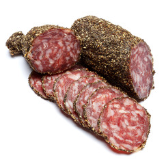 Dried organic salami sausage covered with pepper on white background