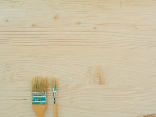 Brush on a wooden background, top view.