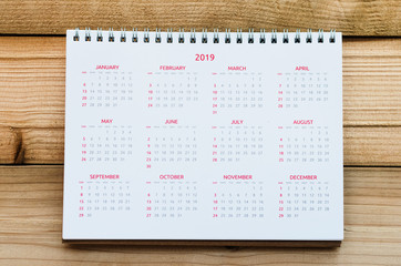 Desktop Calendar 2019 with 12 month on wood board or wood table.