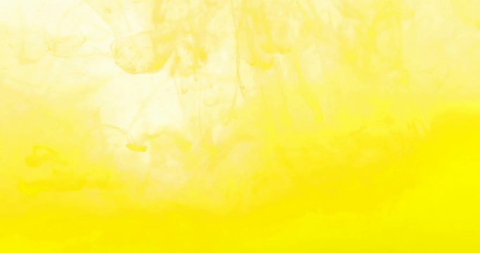 Slow motion yellow ink swirling in water