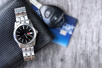 Wallet, wristwatch and car keys used regularly every day for men.