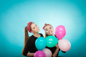 Fototapeta na wymiar Retro girls preparing balloons birthday party.