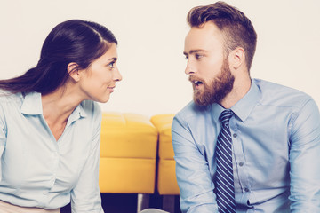 Bearded businessman sharing his opinion with colleague. They discussing or disputing business issues. They looking face to face. Young business people talking. Business concept