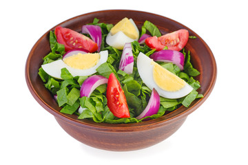 Clay bowl with salad (spinach, egg,onion, tomatoes)