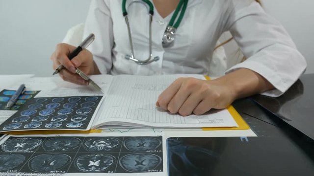 female doctor writes out pills