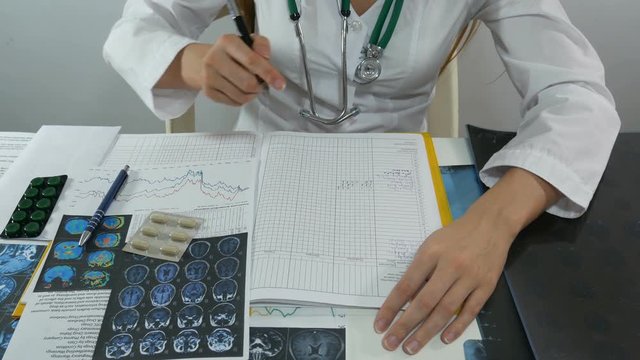 female doctor working at table
