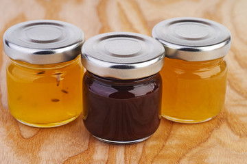 Three glass jars with different jam