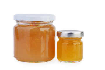 Two glass jars with orange jam or honey