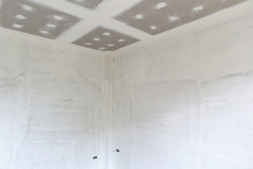Empty room interior with gypsum board ceiling at construction site