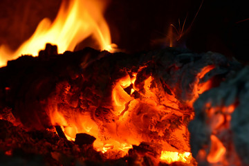 Fire in the fireplace, flames from burning coals on fire