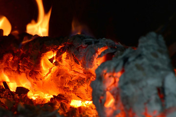 Fire in the fireplace, flames from burning coals on fire