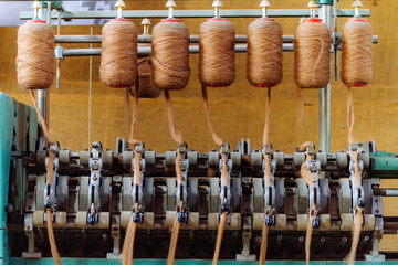 Old wool spinning machine with alpaca fiber spindles