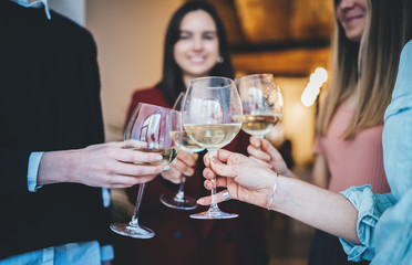 Happy girlfriends celebrating and making cheers with glasses of champagne, young group of hipsters girls having fun at modern loft with healthy food, filtered image, enjoyment and holidays concept