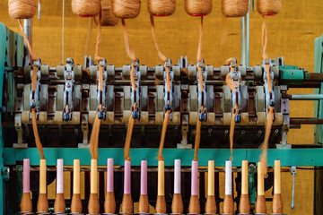 Old wool spinning machine with alpaca fiber spindles
