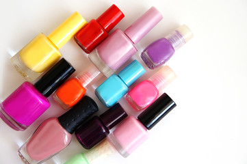 Obraz premium jars with nail varnish of different color and the size on a white background