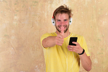 Fototapeta premium Cheerful dj listening songs via earphones.