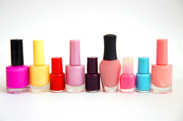 jars with nail varnish of different color and the size on a white background