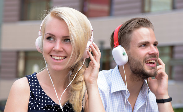 Couple in love listening music in headphones.