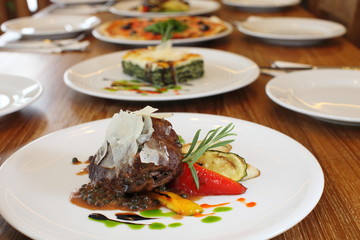 Filet mignon with black pepper sauce background with other italian food