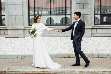 bride and groom walking around the city