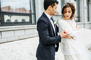 Bride whirls around groom's hand on the city square