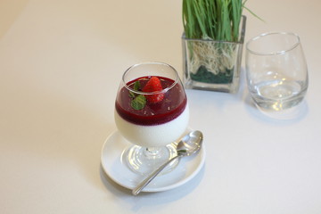 Italian dessert panna cotta with raspberry sauce and fresh strawberry