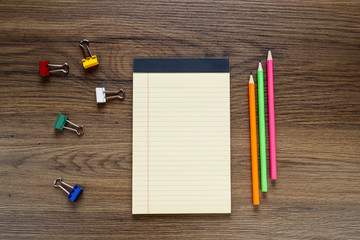 School notebook with pencil on vintage wooden table.