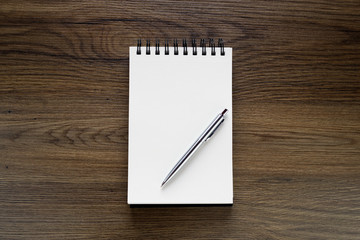 School notebook with pencil on vintage wooden table.