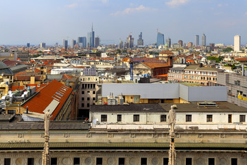 Obraz premium Milan, Italy - Roof architecture of the Cathedral of St. Mary Nascente - Duomo Santa Maria Nascente di Milano at Piazza del Duomo - Cathedral Square and Panoramic view of Milan from cathedral roof