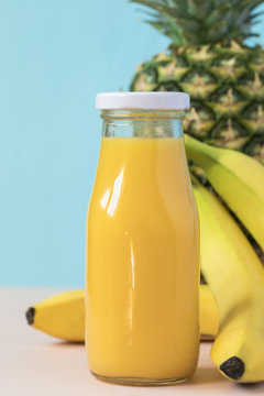 Pineapple and banana juice or smoothie in botle. Natural Organic Food Style.