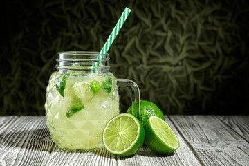 Lemonade in a glass jar with slice of lime