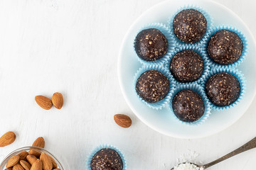 Chocolate energy bites with nuts, cocoa powder, dates and coconut flakes. - 198360612