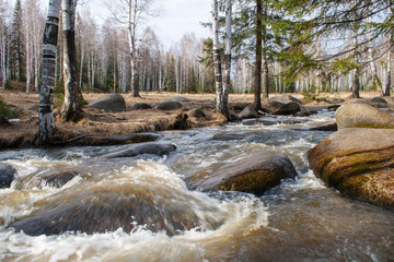 A river with a fast current. In the river big stones