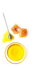 Apiary products. Honey in bowl and honeycomb on white background top view copy space close up