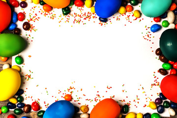 Delicious easter eggs and sweets on a wooden background