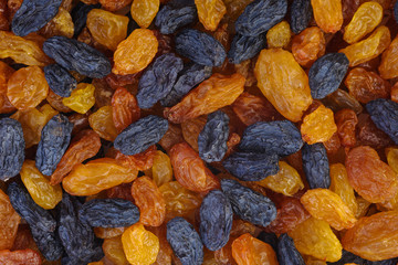 Abstract background: Mix of amber and black raisins