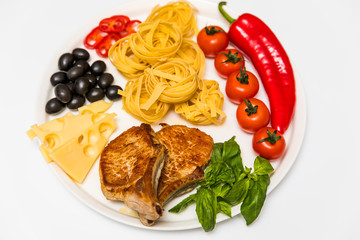 Fried pork ribs with spaghetti, cherry tomatoes, basil, olives, hot pepper and cheese
