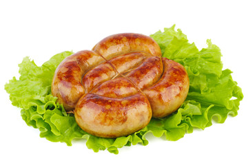 Grilled homemade sausage over fresh lettuce leaf