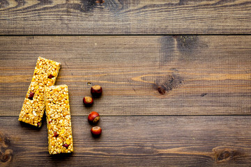 Energy protein snacks with hazelnuts on dark wooden background top view copy space