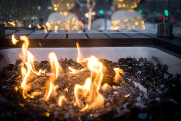 Yellow blazing flame in glass fire pit