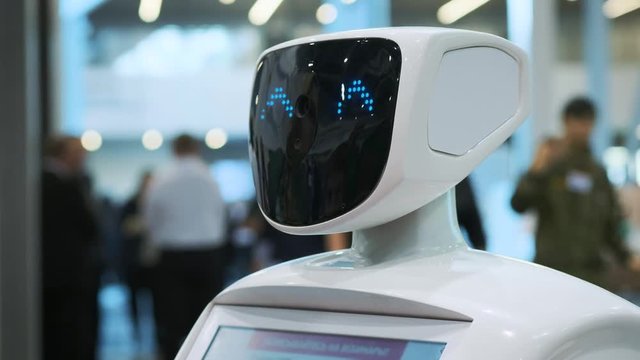 Modern Robotic Technologies. The robot looks at the camera at the person. The robot shows emotions.