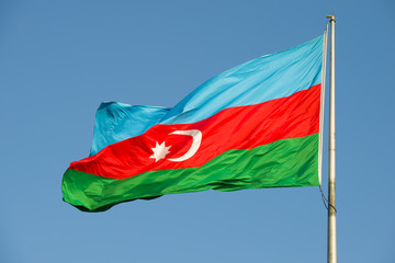 The national flag of Azerbaijan close-up against the blue sky